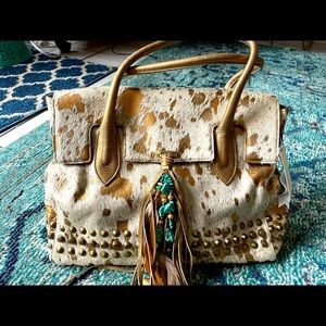 Women’s Genuine metallic leather and calf hair handbag.